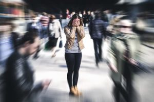 Woman feeling overwhelmed. Fawning is the act of people-pleasing as a survival strategy.